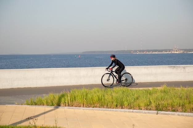 View of the cyclist against the background of the promenade of the Gulf of Finland