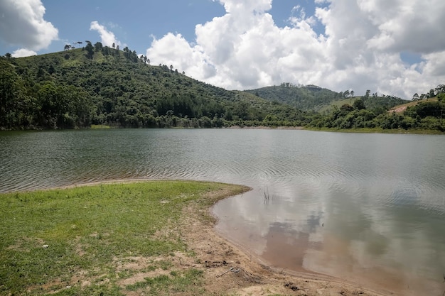 View Dam with fisherman with lots of tropical brazilian summer sun and dog swimming