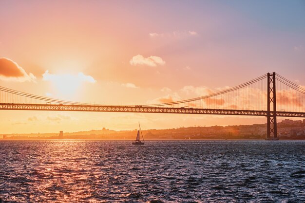 View of de abril bridge over tagus river at sunset lisbon portugal