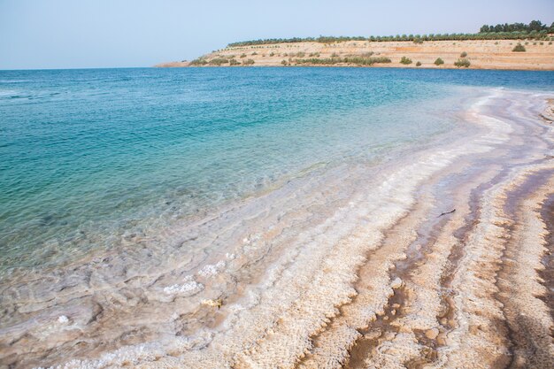 View of Dead Sea coastline at sunset time in Jordan