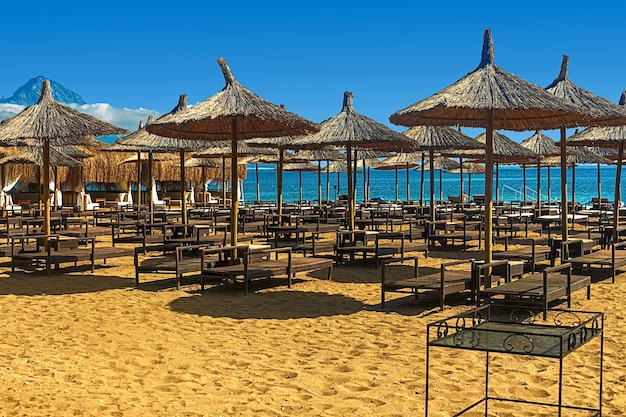 View of deck chairs and umbrellas on the sandy beach of Kemer Turkey