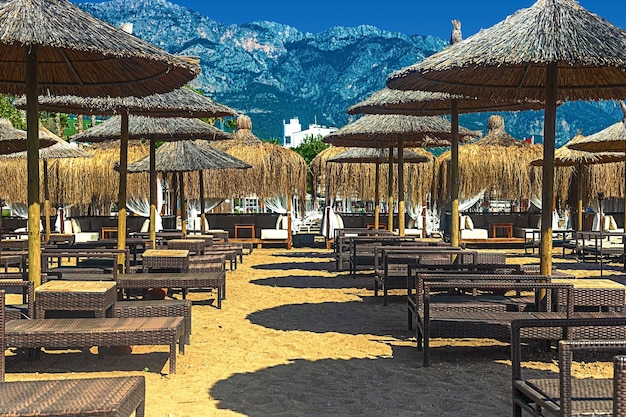 View of deck chairs and umbrellas on the sandy beach of Kemer Turkey