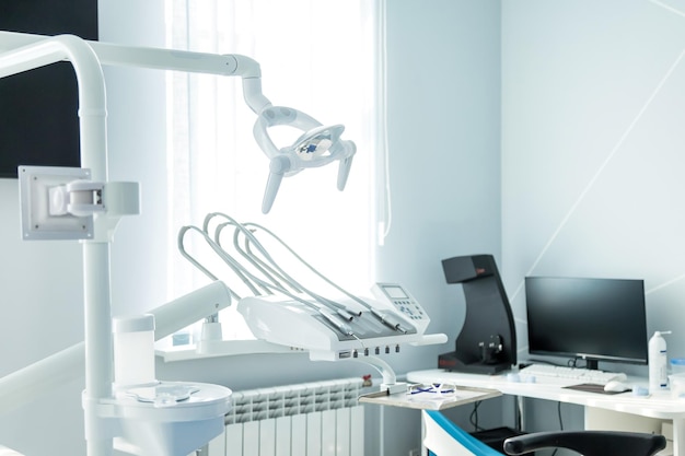 View dental equipment in dentist office in new modern\
stomatological clinic room background of dental chair and\
accessories used by dentists in blue