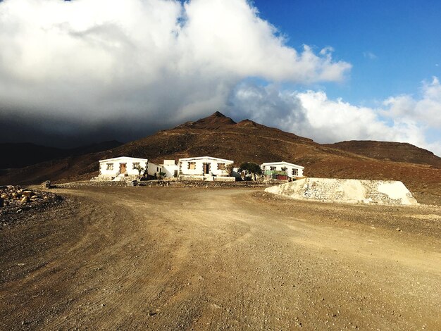 View of desert against cloudy sky