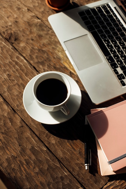 view of the desktop with coffee and laptop