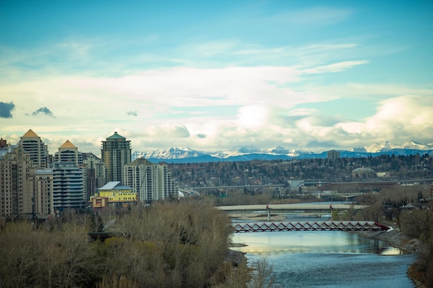 View of downtown calgary with bridges and the rockies