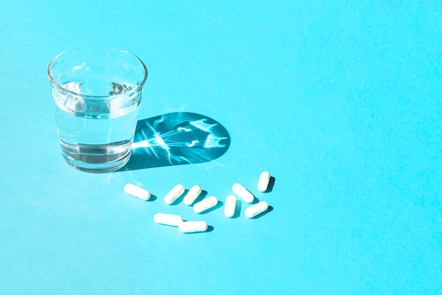 View of drink in glass over water against blue background