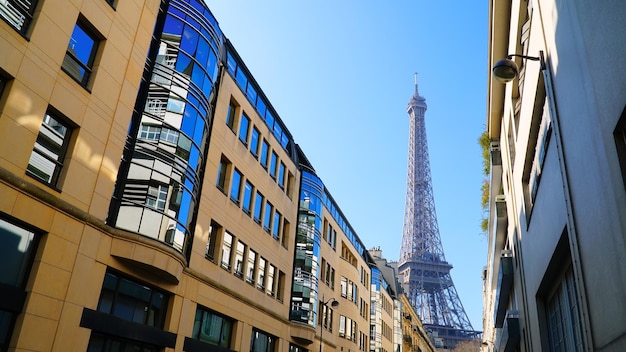 View on Eiffel Tower and urban street in Paris, France