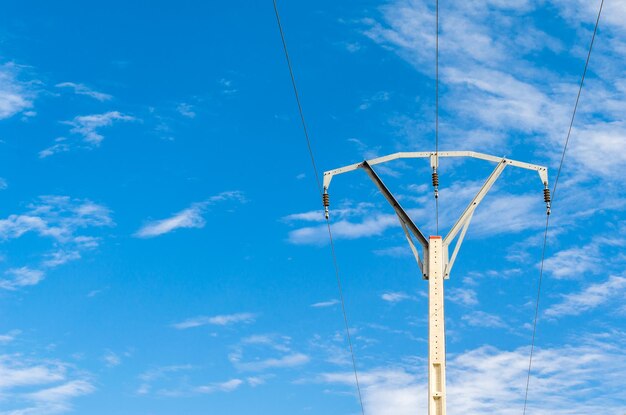 View of an electric power pole with blue sky background