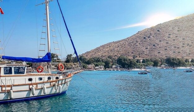 View of the embankment of a resort town in turkey with boats moored at the pier palm trees