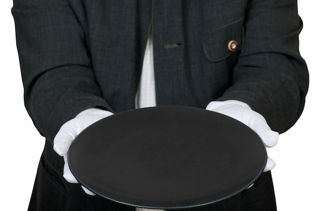 Above view of empty black plate in hands in gloves