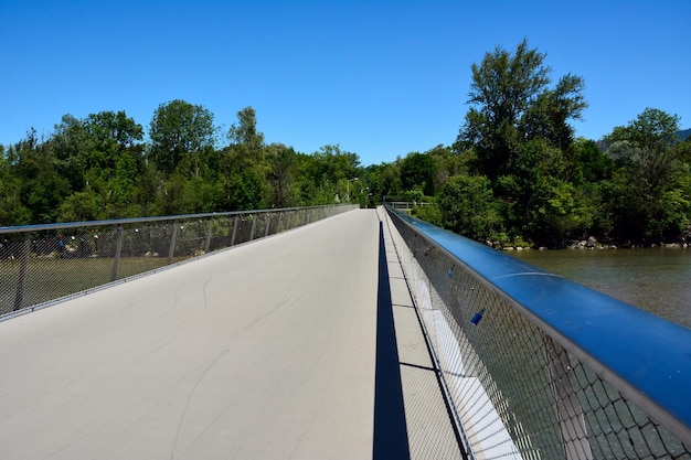 A view of an empty bridge in the perspective of a city green park