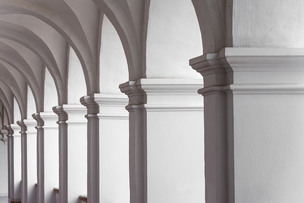 View of empty courtyard with white archs. Minimal architecture