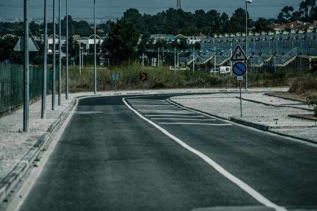 View of empty road against plants in city