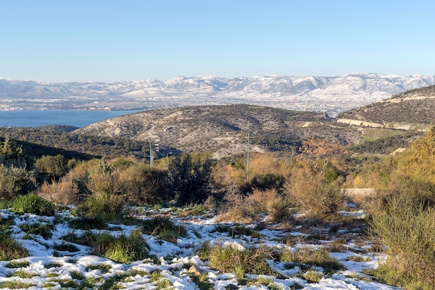 View on environmental park Peramatos - Schistos in Athens District (Greece) on a sunny, snowy, winter day