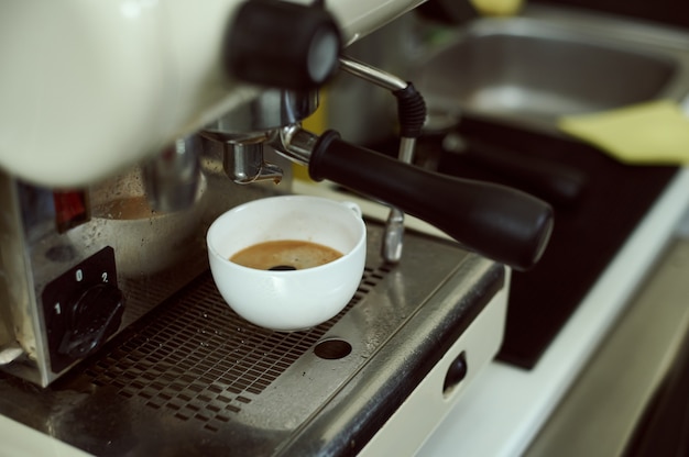 View of espresso cup on a professional coffee machine