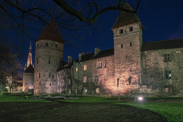 View to the european city Tallinn after sunset in twilight, travel outdoor background. Wall of the Old Town.