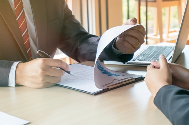 View of a Examiner reading a resume during a job interview