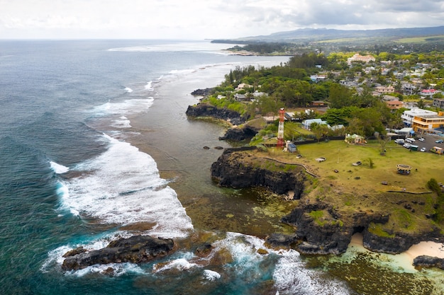 View of the famous Golden beach between black volcanic rocks on the banks of the Gris-Gris river, La Roche qui pleure in Mauritius