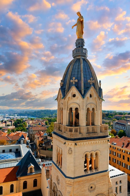 View of famous Marie statue on top of Notredamedefourviere basilica in Lyon at sunset