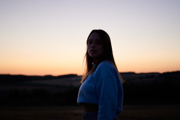 A view of female in a backlighting against a the sunset