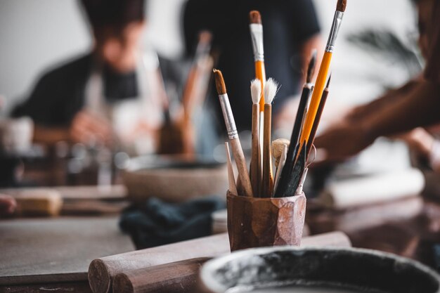 View of female hands works with clay makes future ceramic plate
ceramic artist makes classes of hand building in modern pottery
workshop creative people handcrafted design