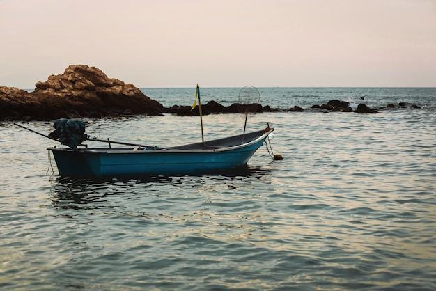 View of fishing boats moored on the seashore in the evening