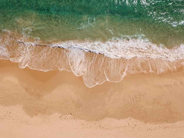 View of foam waves on seaside from above