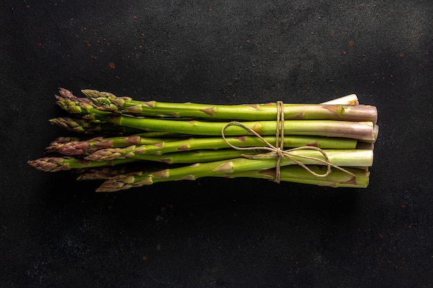 View of fresh asparagus on a black table.