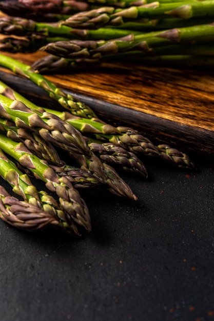 View of fresh asparagus on a black table.