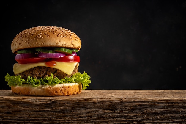 View of fresh tasty burger on wooden rustic table