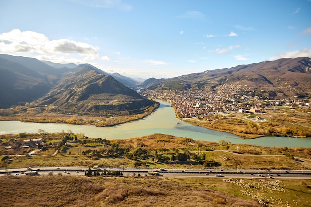 View from afar of the town of mtskheta the unesco world heritage city and the mtskheta river in a bl...