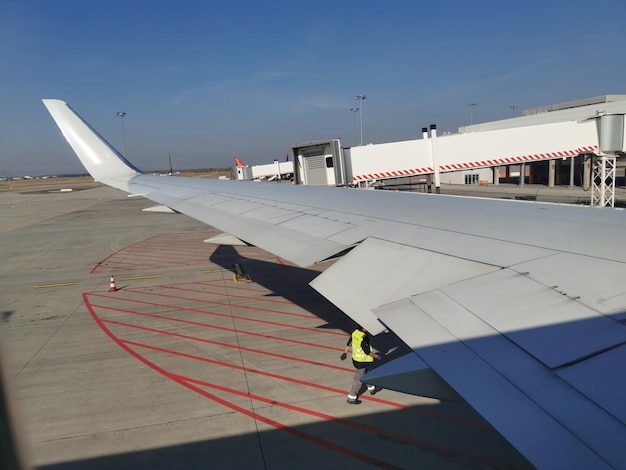 写真 航空機の窓からの眺め。空港の飛行機の翼