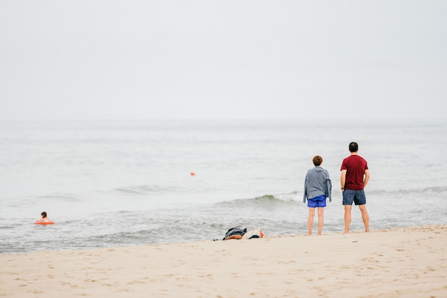 View from back of man and woman looking at sea