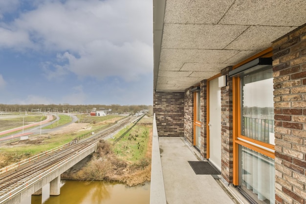 View from the balcony of a residential building built of light and dark brick on the railway and the highway network