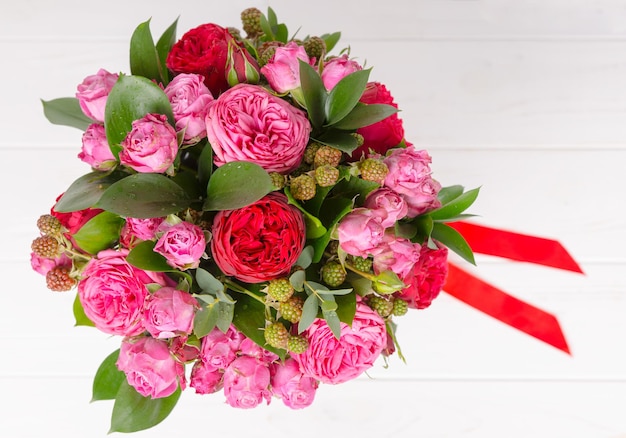 View from above of a beautiful bouquet of pink and red roses isolated on white background. Valentines and anniversary concept