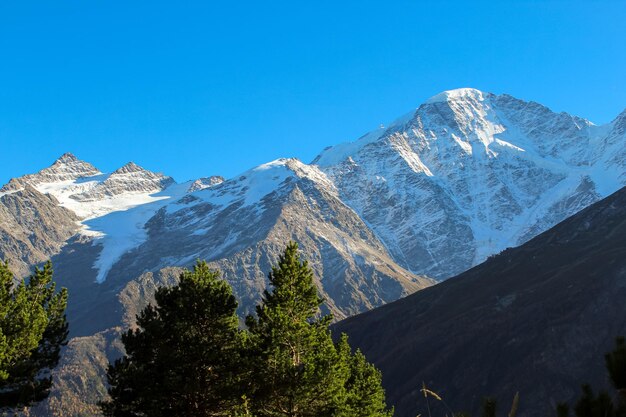 View from cheget mountain mountains in the snow elbrus region blue sunset sky with copy space for text