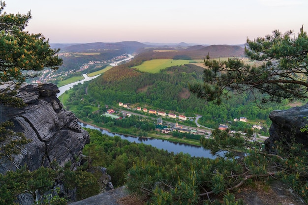 View from the cliff of the village landscape spacious green meadows endless open spaces saxon switzerland national park near dresden germany