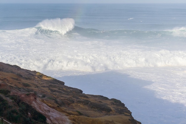 View from the cliff to the waves in Nazare