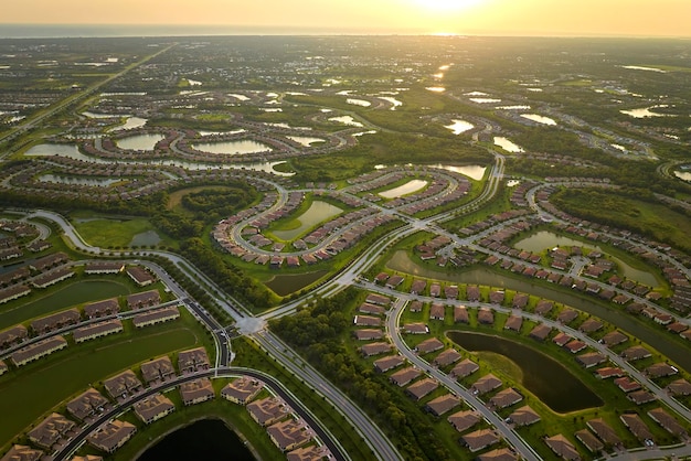 View from above of densely built residential houses in closed\
living clubs in south florida american dream homes as example of\
real estate development in us suburbs