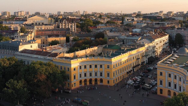 View from drone of urban street scape and buildings many people walking around