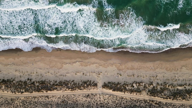 View from a flying drone over a deserted sandy sea coast