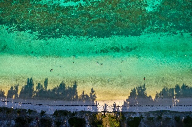 View from the height of the east coast of the island of Mauritius. Flying over the turquoise lagoon of the island of Mauritius in the area of Bel Mare.