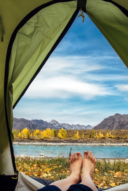 View from inside the tent of bare feet