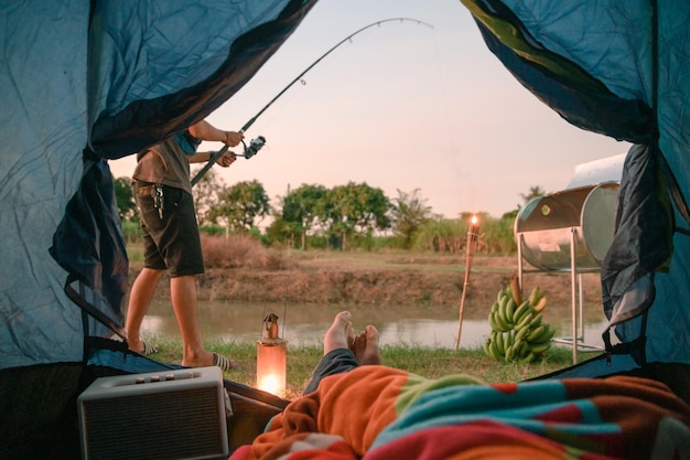 View from inside of tent with relaxing and fishing in swamp