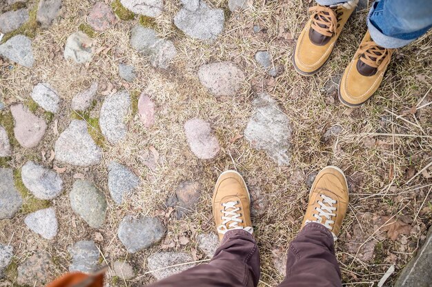 A view from above on the legs of a man and a woman standing opposite each other