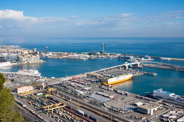 View from Montjuic Castle of Barcelona industrial port docked with ships, cranes and containers