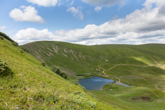 View from above of mountain lake Dohyaska surrounded by mountains Svydovets