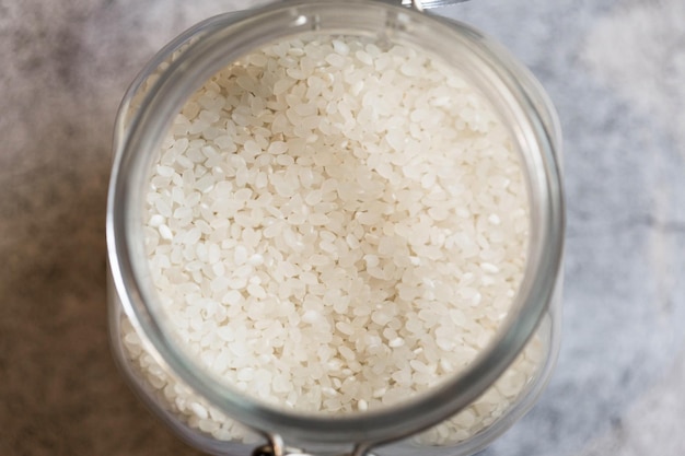 View from above of open glass jar with rice Kitchen storage