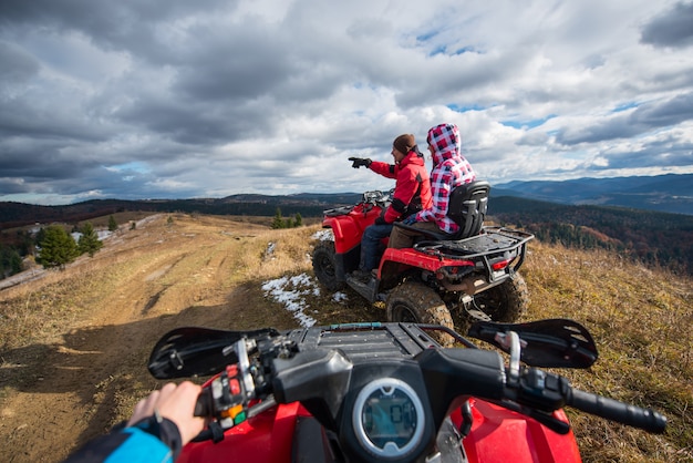 view from a quad bike. Couple sitting on atv.